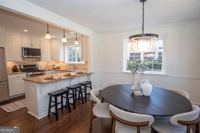 dining space with ornamental molding, recessed lighting, and dark wood-style flooring