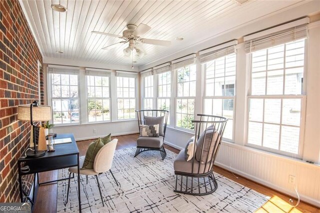 sunroom / solarium featuring ceiling fan and wooden ceiling