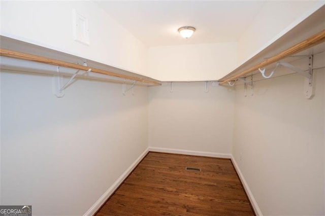 walk in closet with visible vents and wood finished floors