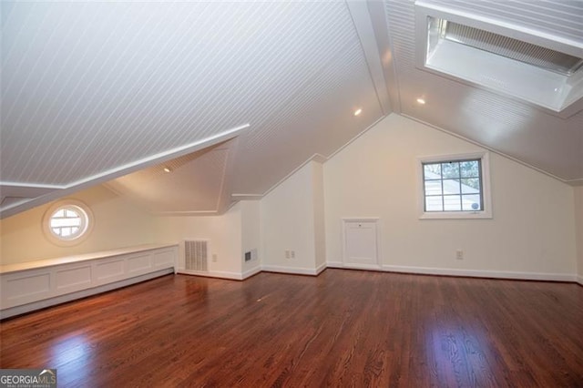 additional living space featuring lofted ceiling with beams, wood finished floors, visible vents, and baseboards