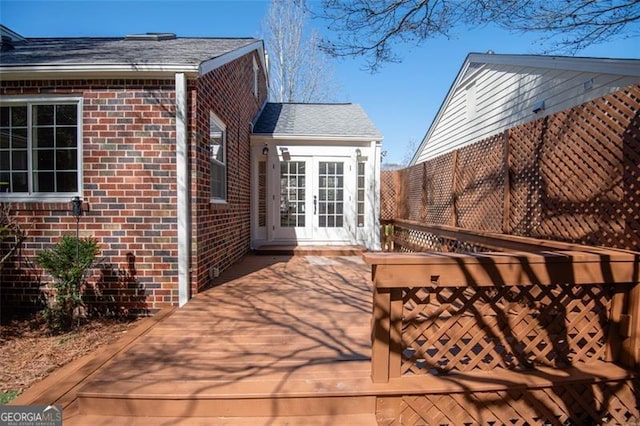 exterior space with a deck and french doors