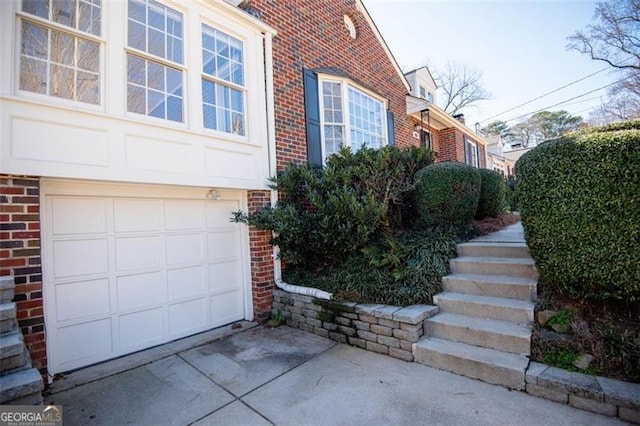 view of side of property with brick siding and driveway