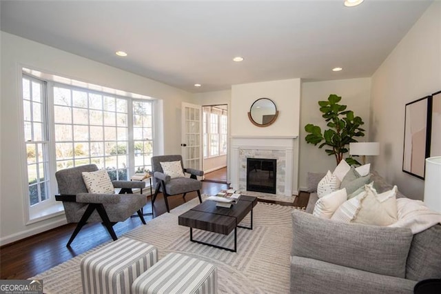 living room with wood finished floors, a wealth of natural light, and recessed lighting