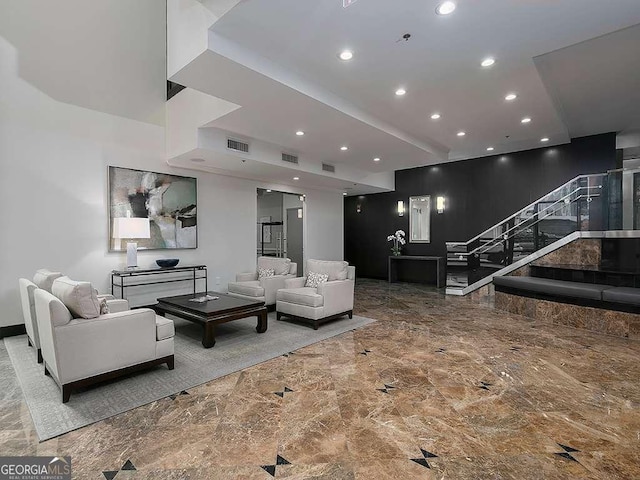 living room with recessed lighting, marble finish floor, visible vents, and stairway