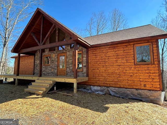 view of front of house with crawl space and a shingled roof