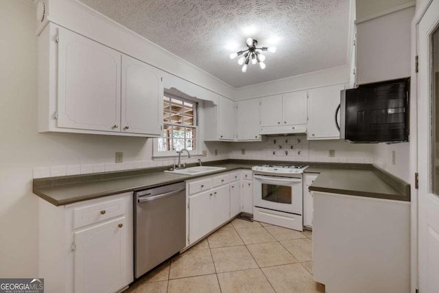 kitchen with dishwasher, dark countertops, a sink, and white range with gas cooktop