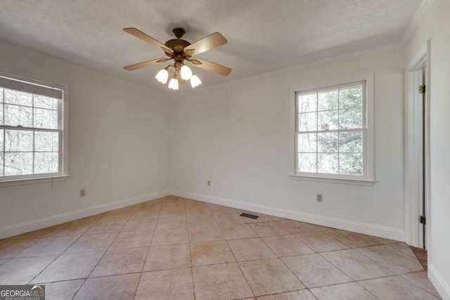 spare room featuring crown molding and a healthy amount of sunlight