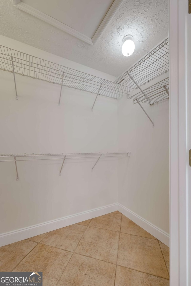 walk in closet featuring light tile patterned flooring