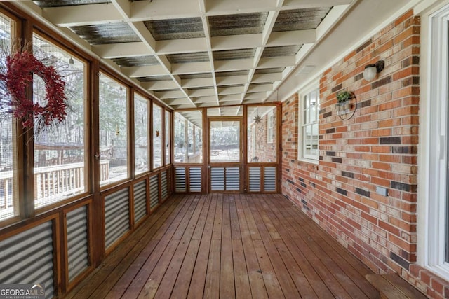 unfurnished sunroom with plenty of natural light and coffered ceiling