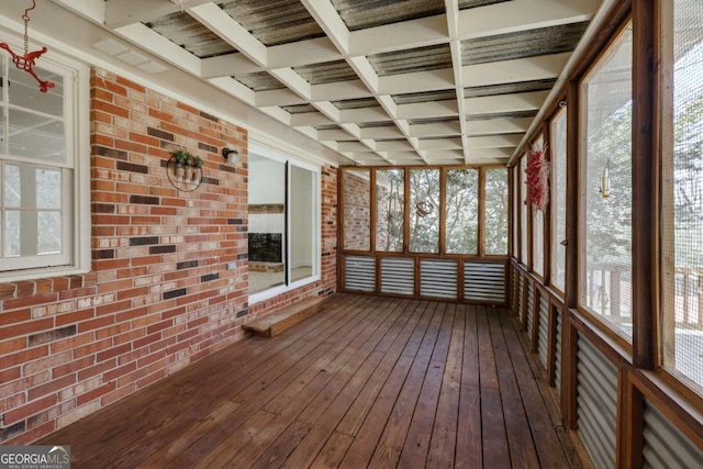 unfurnished sunroom featuring coffered ceiling and a wealth of natural light