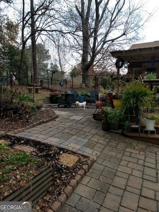 view of patio featuring fence