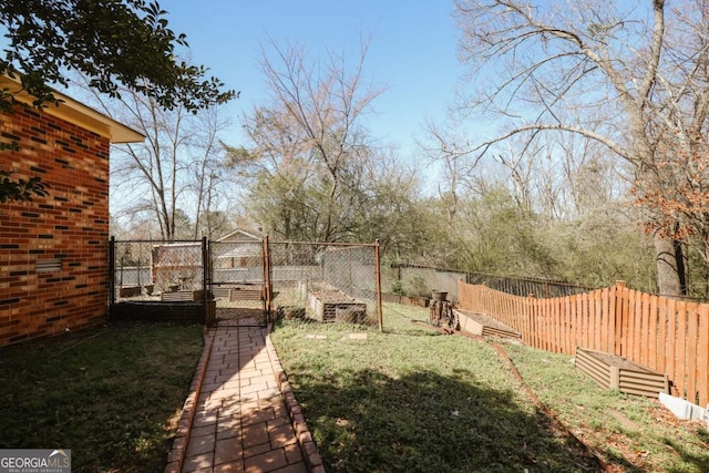 view of yard with a garden and fence