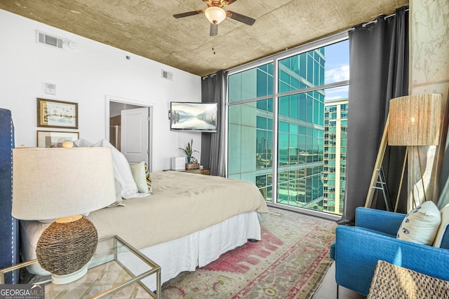 bedroom with visible vents and expansive windows