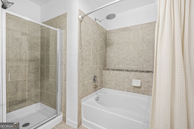 bathroom featuring a shower stall and a bathing tub