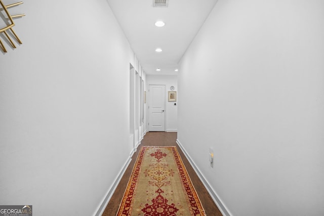 hall with visible vents, recessed lighting, wood finished floors, and baseboards