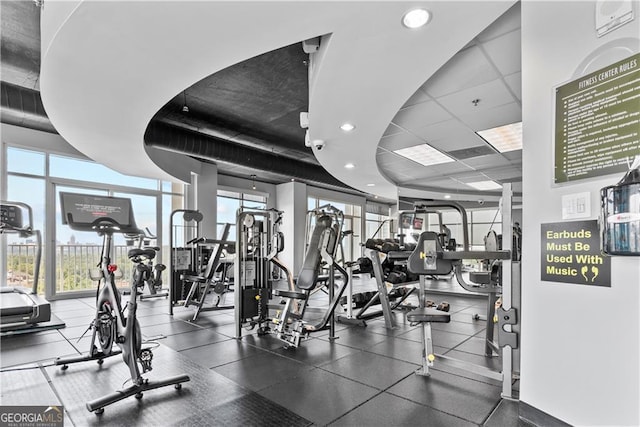 exercise room featuring recessed lighting and a drop ceiling