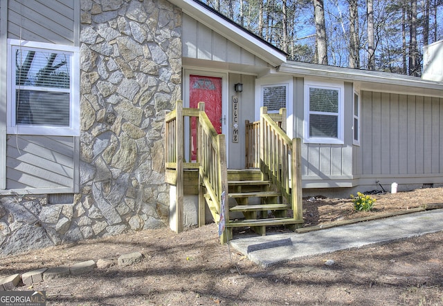 doorway to property with stone siding and crawl space