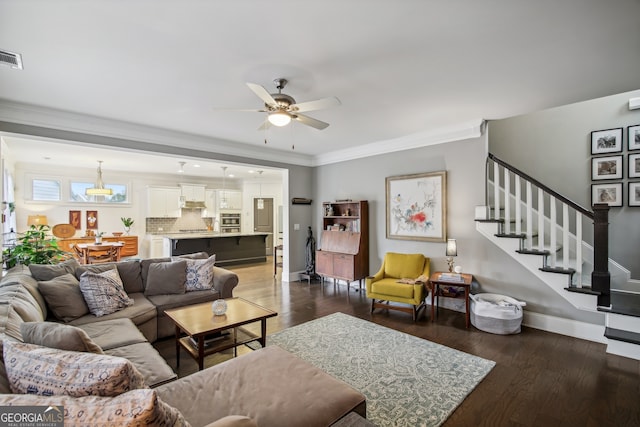 living room with baseboards, a ceiling fan, stairway, dark wood-style flooring, and crown molding