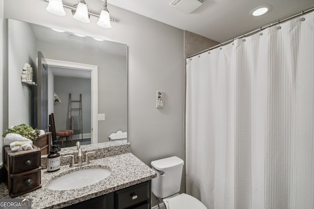 full bathroom with a shower with curtain, visible vents, vanity, and toilet