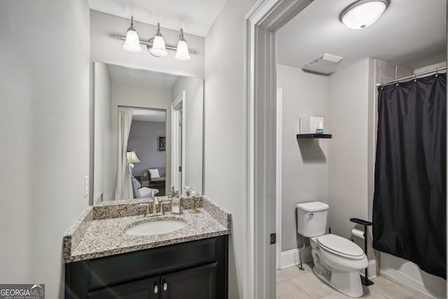 ensuite bathroom with visible vents, toilet, connected bathroom, vanity, and tile patterned floors