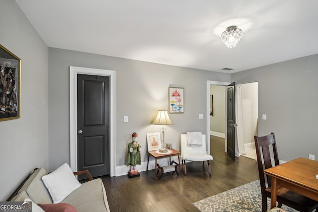 interior space featuring baseboards, visible vents, and dark wood finished floors