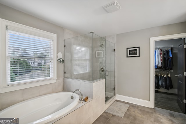 full bathroom with tile patterned flooring, a garden tub, visible vents, a spacious closet, and a stall shower