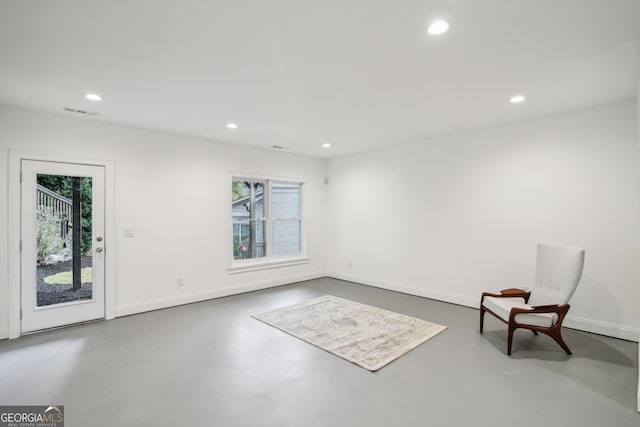 unfurnished room featuring concrete flooring, recessed lighting, and baseboards