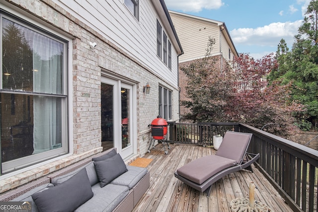 wooden terrace with grilling area and an outdoor hangout area