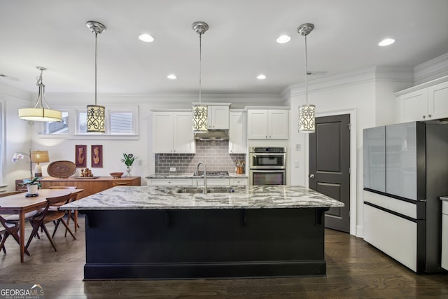 kitchen featuring double oven, a sink, ornamental molding, backsplash, and freestanding refrigerator