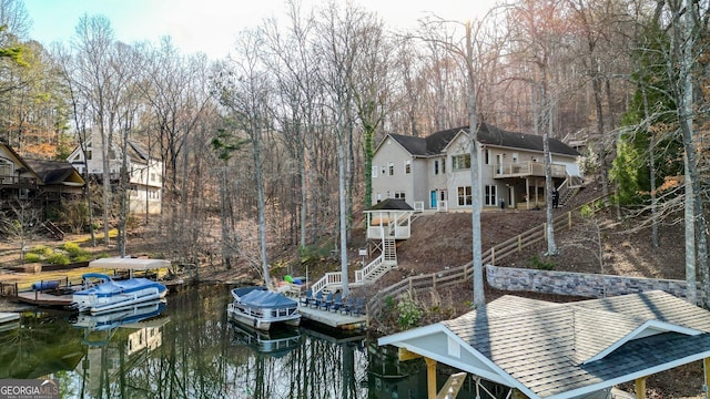 view of dock with a deck with water view, boat lift, and stairs