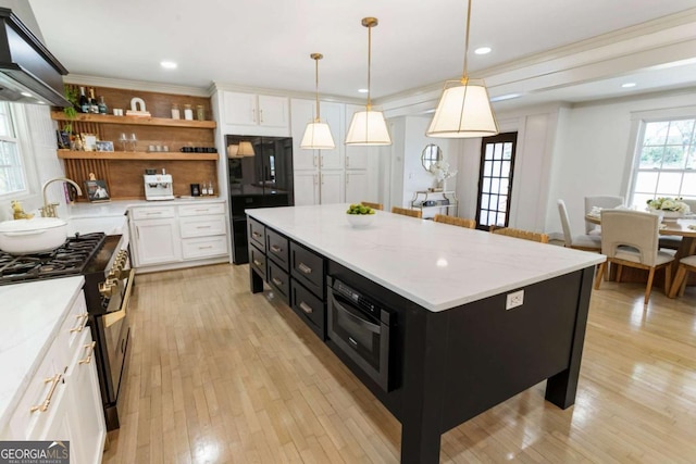 kitchen featuring open shelves, white cabinetry, high end range, and dark cabinetry