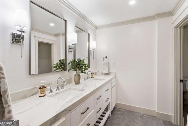 full bathroom featuring double vanity, ornamental molding, and a sink