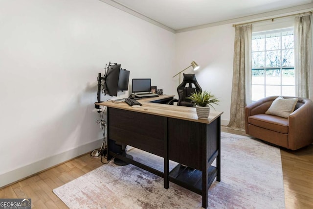 home office featuring crown molding, baseboards, and wood finished floors