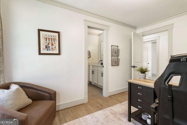 home office with baseboards and light wood finished floors