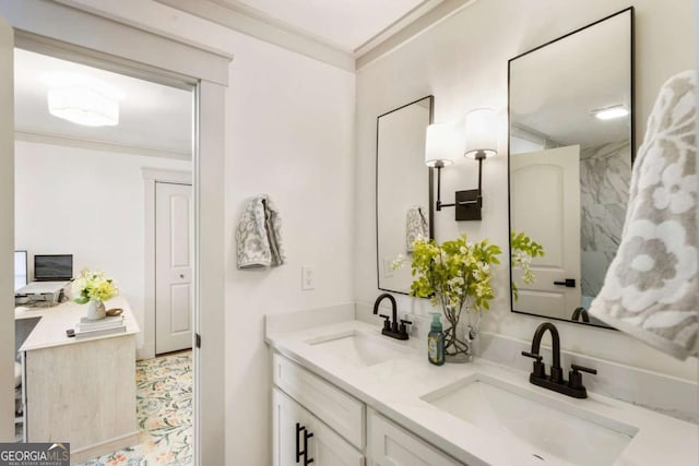 full bath with double vanity, crown molding, and a sink