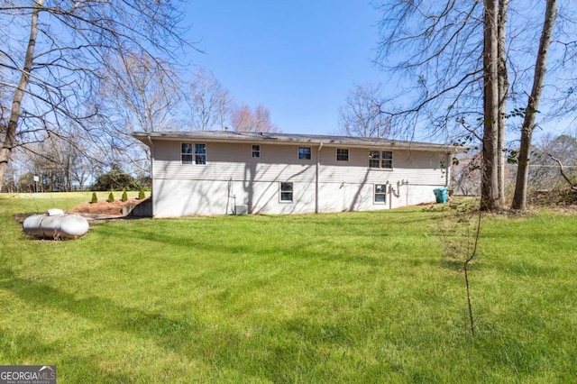 rear view of house with a yard