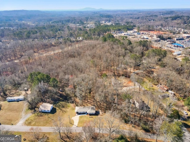 drone / aerial view with a wooded view