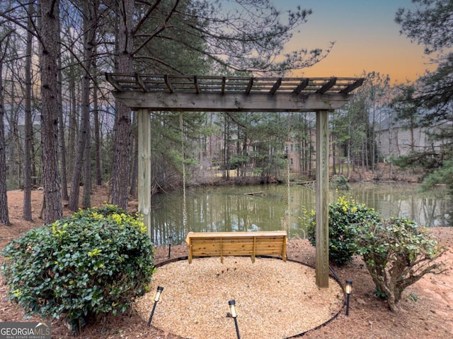 exterior space with a water view and a pergola