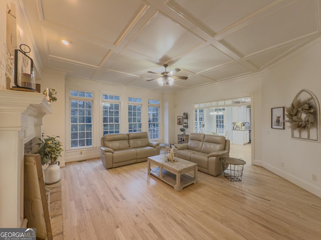 living area featuring baseboards, ceiling fan, light wood-style flooring, a fireplace, and coffered ceiling