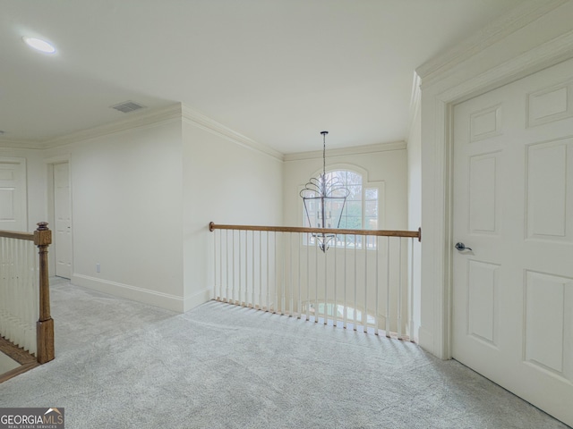 hall with crown molding, an upstairs landing, carpet, and visible vents