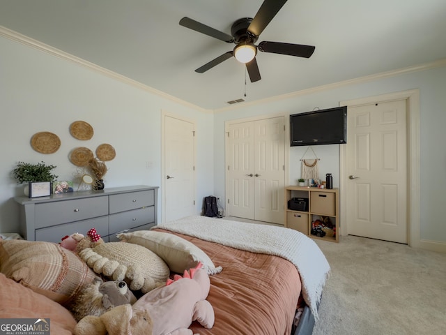 bedroom featuring visible vents, light carpet, a closet, and crown molding