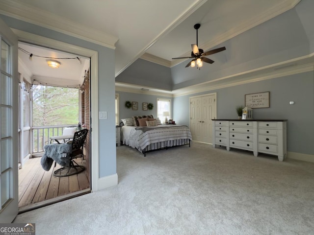 bedroom with ornamental molding, a tray ceiling, carpet floors, baseboards, and ceiling fan