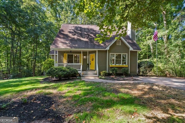 cape cod home with a front yard, covered porch, and a chimney