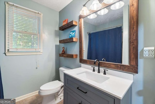 bathroom with a textured ceiling, toilet, vanity, baseboards, and a shower with curtain