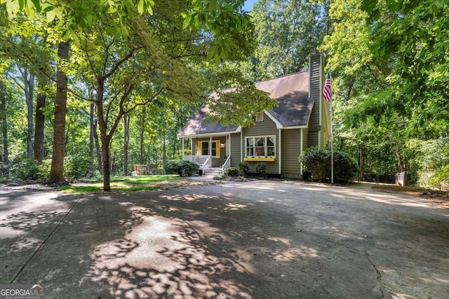 view of front of house with covered porch and a chimney