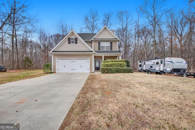 view of front of property featuring a garage, a front yard, and concrete driveway