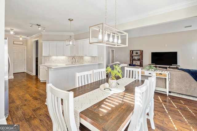 dining area with visible vents, ornamental molding, and dark wood-style flooring