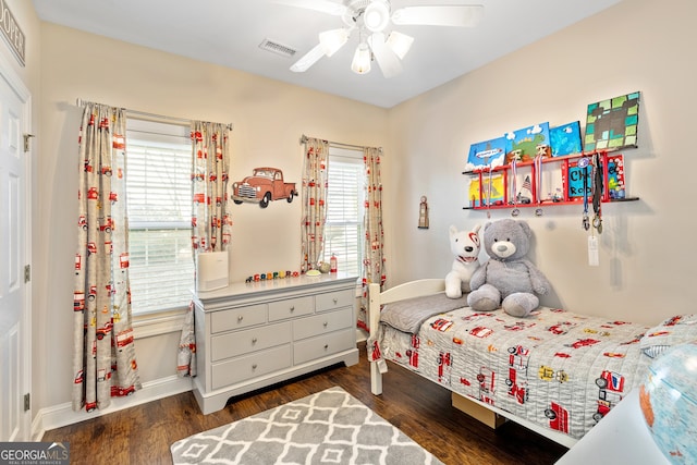 bedroom featuring multiple windows, wood finished floors, and visible vents