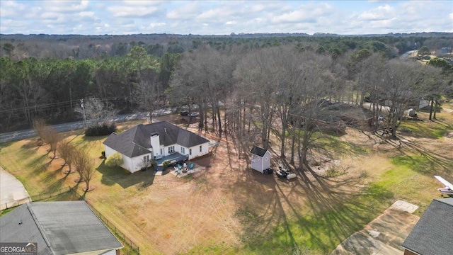 birds eye view of property with a forest view