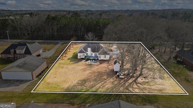 bird's eye view featuring a wooded view